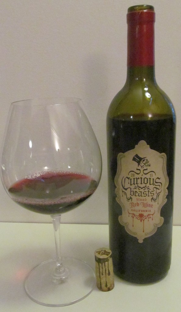 Curious Beasts blood red wine 2011 and glass of wine