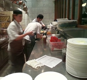 Preparing food at the open kitchen at West
