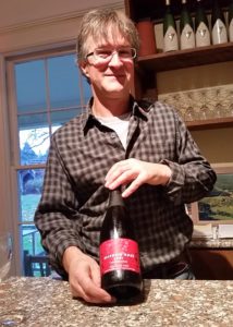 Jim with a bottle of his Allegria Rose Brut sparkling wine
