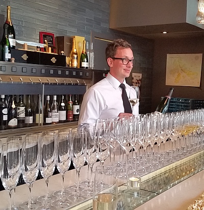 Joshua Carlson ready to offer a glass of Champagne at TWB The Wine Bar