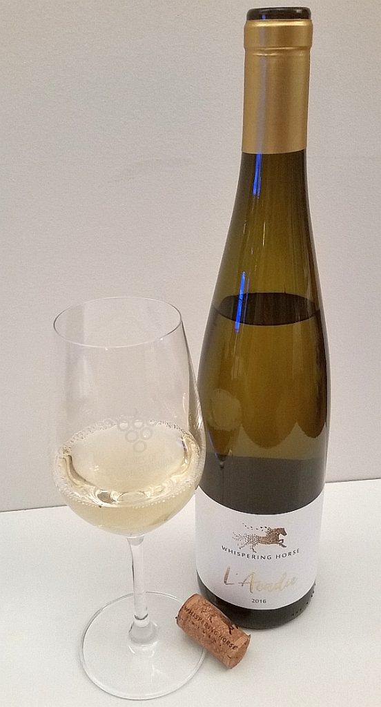 Whispering Horse L'Acadie bottle with wine in glass