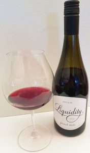 Liquidity Estate Pinot Noir 2016 with wine in glass