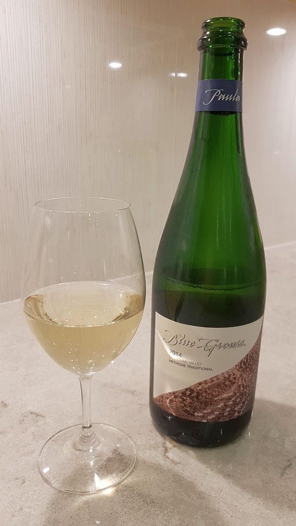 Blue Grouse Paula sparkling wine with wine in glass