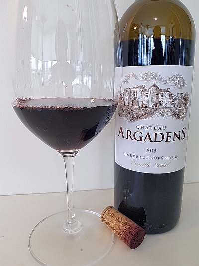 Chateau Argadens Red 2015 with wine in glass