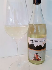 Gratitude by JAK's Pinot Blanc 2019 with wine in glass