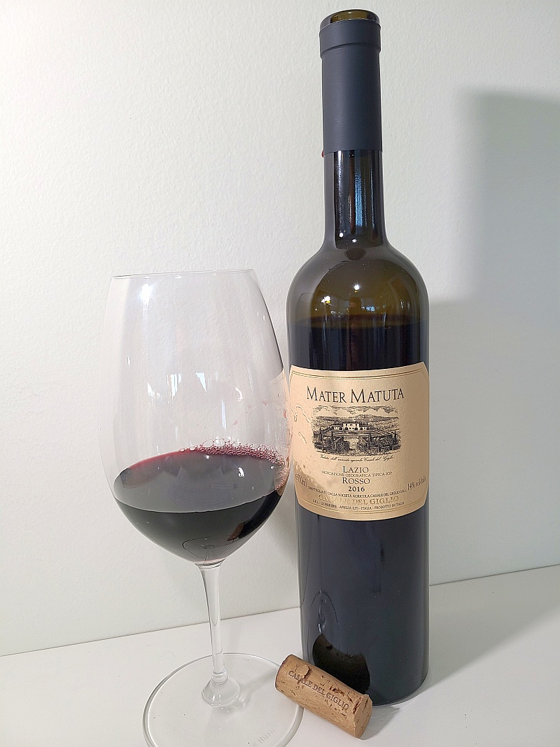 Casale del Giglio Mater Matuta Rosso IGT 2016 with wine in glass