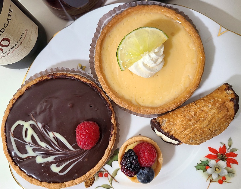 A cannoli, mini fresh berry tart, lime tart, and dark chocolate raspberry tart from Whole Foods