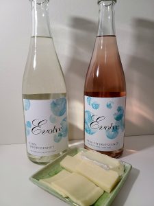 Evolve Cellars Elan Effervescence, NV and Pink Effervescence, NV with a selection of brie, cheddar, and gouda cheeses
