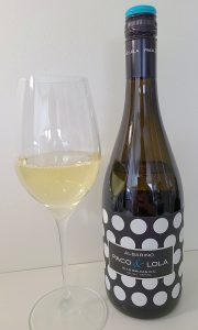 Paco & Lola Albariño 2019 with wine in glass
