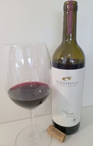 Summerhill Pyramid Winery Organic Syrah 2019 with wine in a glass