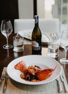 Lobster dinner with wine Photo by ROMAN ODINTSOV from Pexels