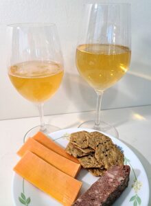 Creek & Gully Fortuna (L) and Goldie (R) ciders paired with cheddar cheese, pate, and multigrain crackers