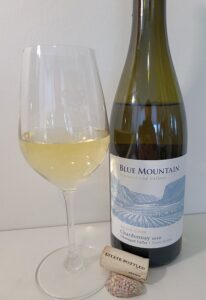Blue Mountain Vineyard and Cellars Estate Cuvee 2020 Chardonnay with wine in glass