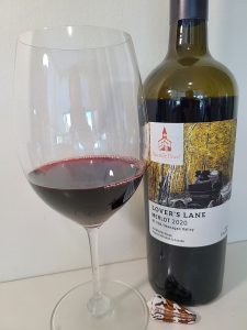 Seaside Pearl Lover's Lane Merlot 2020 with wine in glass