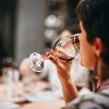 Person sipping wine (Photo by Helena Lopes)