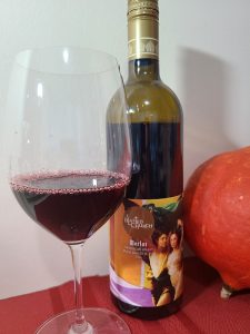 Blasted Church Vineyards Merlot 2021 with wine in glass