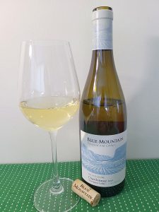 Blue Mountain Vineyard and Cellars Estate Cuvée Chardonnay 2022 with wine in glass