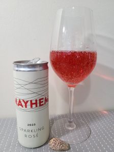 Mayhem Wines Sparkling Rose 2023 with wine in glass