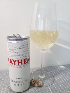 Mayhem Wines Sparkling White 2023 with wine in glass