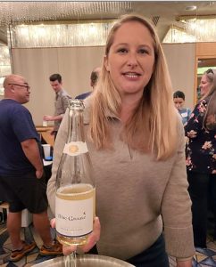 Wine maker from Blue Grouse pouring Charme de l'ile wine