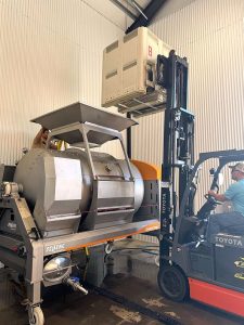 Black Market Wine Co tipping a bin to the press