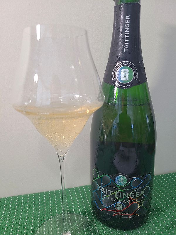 Champagne Taittinger Brut Reserve FIFA Edition with wine in glass