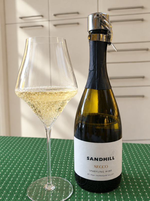 Sandhill Secco Sparkling Wine with wine in glass